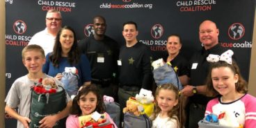 CEO/ Founder Carly Yoost with members of PBSO and local children in the community at our Blankets & Bear Hugs Event in January.
