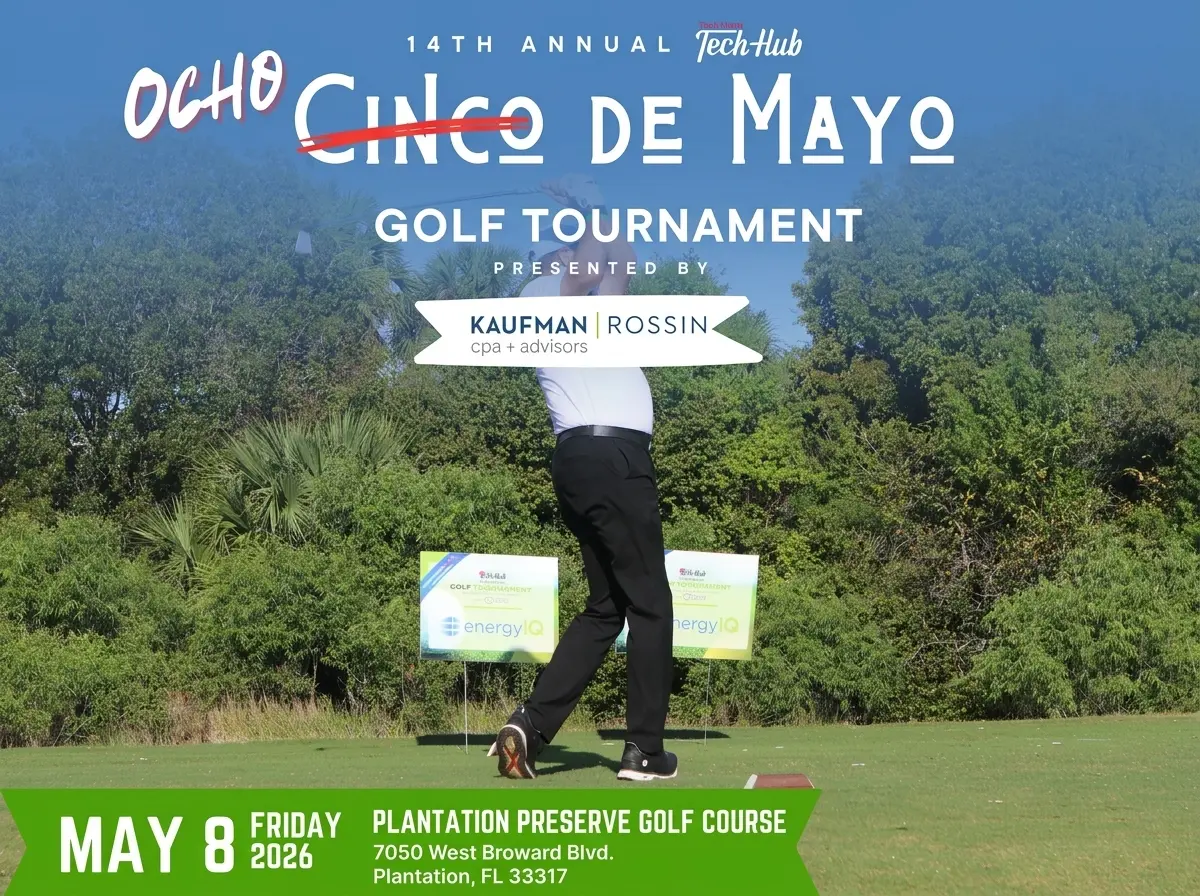 Wide landscape view of the putting green at Plantation Preserve Golf Course during the 14th Annual Tech Hub Golf Invitational, featuring several golfers networking under a blue sky.